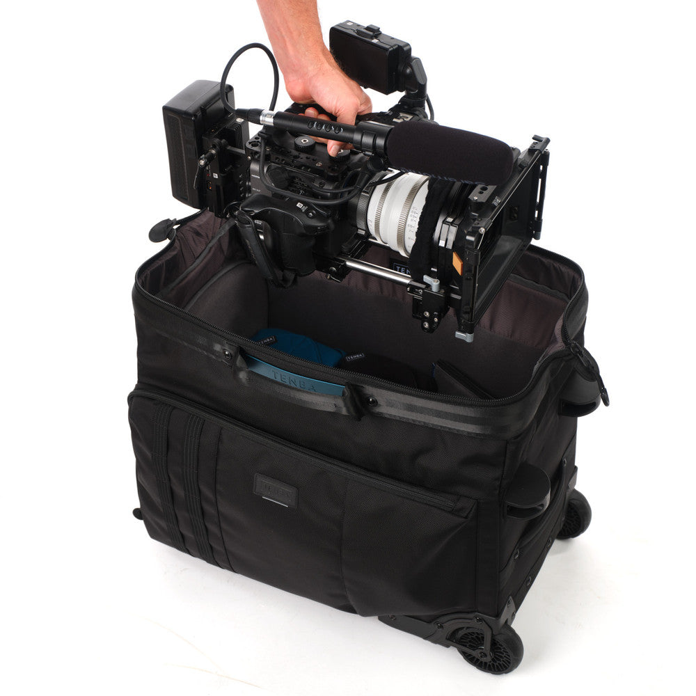 Black camera bag with a camera inside on a white background