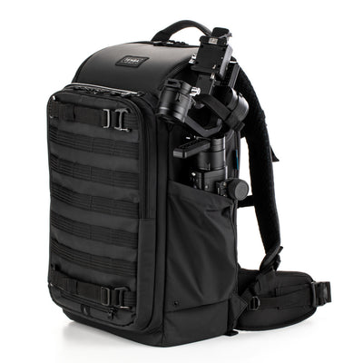 Black backpack with camera equipment on a white background