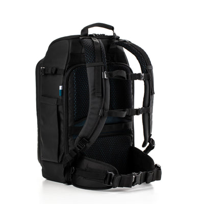 Black backpack with multiple compartments and straps on a white background