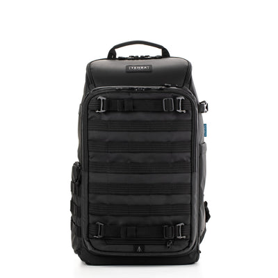 Black backpack with multiple compartments and straps on a white background