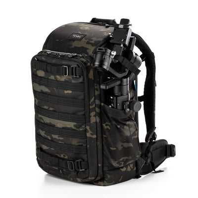 Camouflage backpack with tactical equipment on a white background