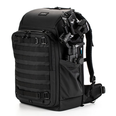 Black backpack with camera equipment on a white background