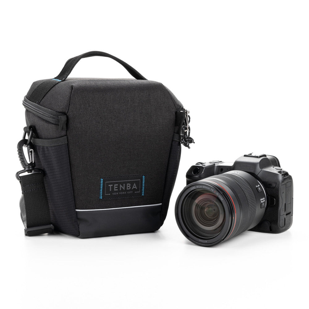 Black camera bag with a camera on a white background