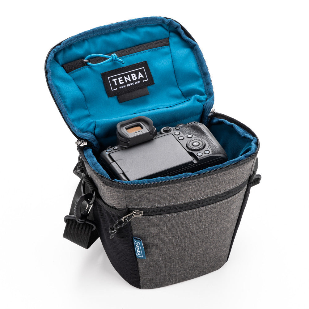 Gray camera bag with blue interior containing a camera, on a white background