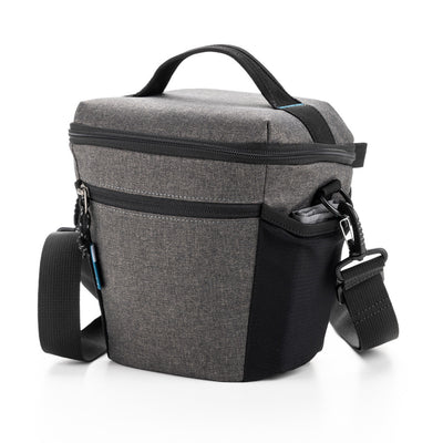 Gray and black camera bag with a shoulder strap on a white background