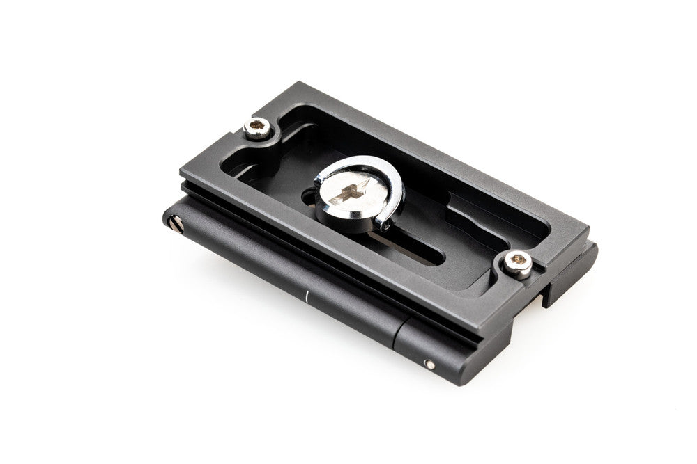 Black metal plate with a central circular component on a white background