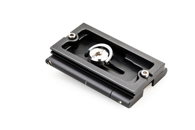 Black metal plate with a central circular component on a white background