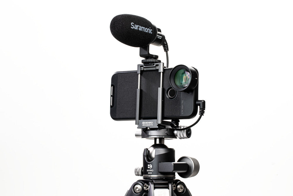 Phone mounted on a tripod with a Saramonic microphone on a white background