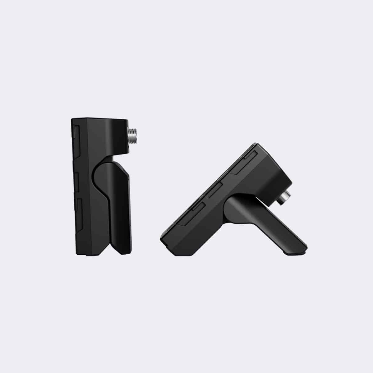 Two black clamps on a light gray background