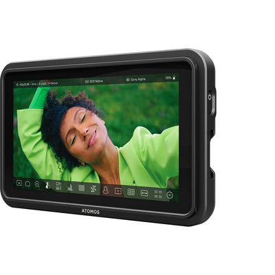 Display device with a person in a green shirt on the screen, branded 'ATOMOS'.