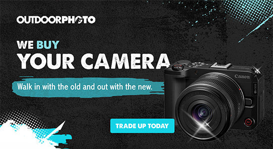 Advertisement for Outdoorphoto offering camera trade-in service.