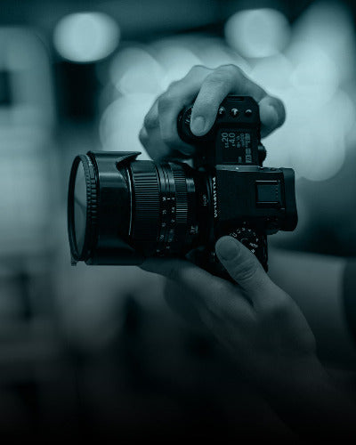 Person holding a camera with a blurred background