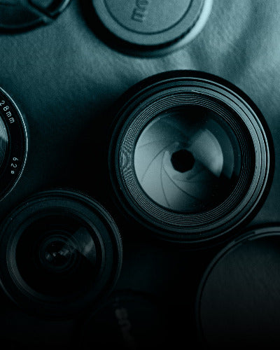 Close-up of camera lenses with a blue tint