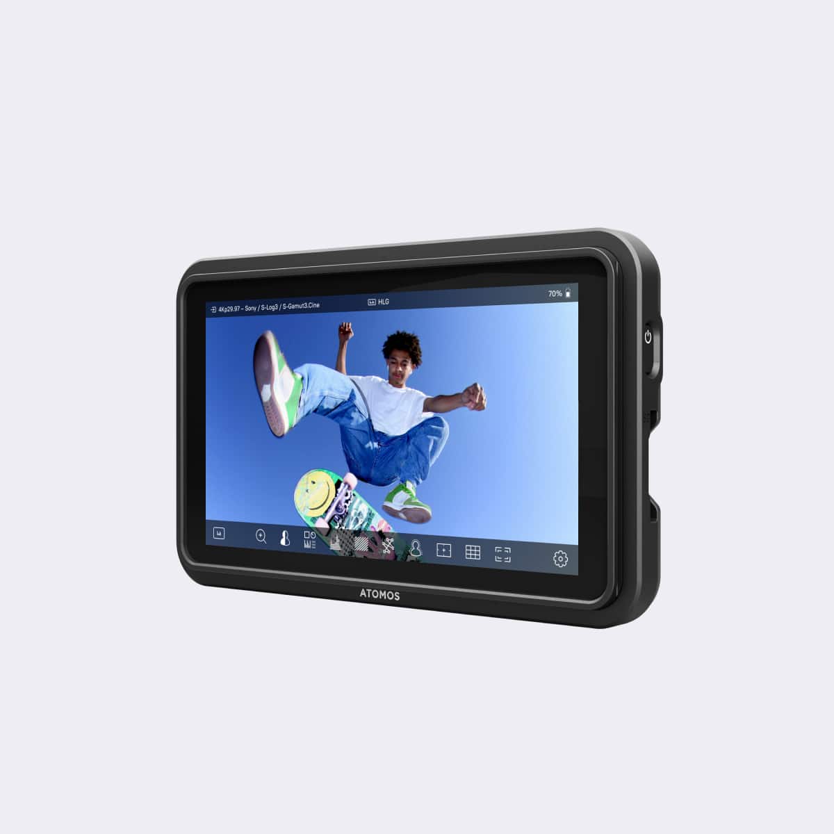 Display device with a screen showing a person on a skateboard, branded 'Atomos', on a light gray background