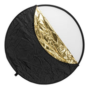 Round photography reflector with black, gold, and white sections on a white background