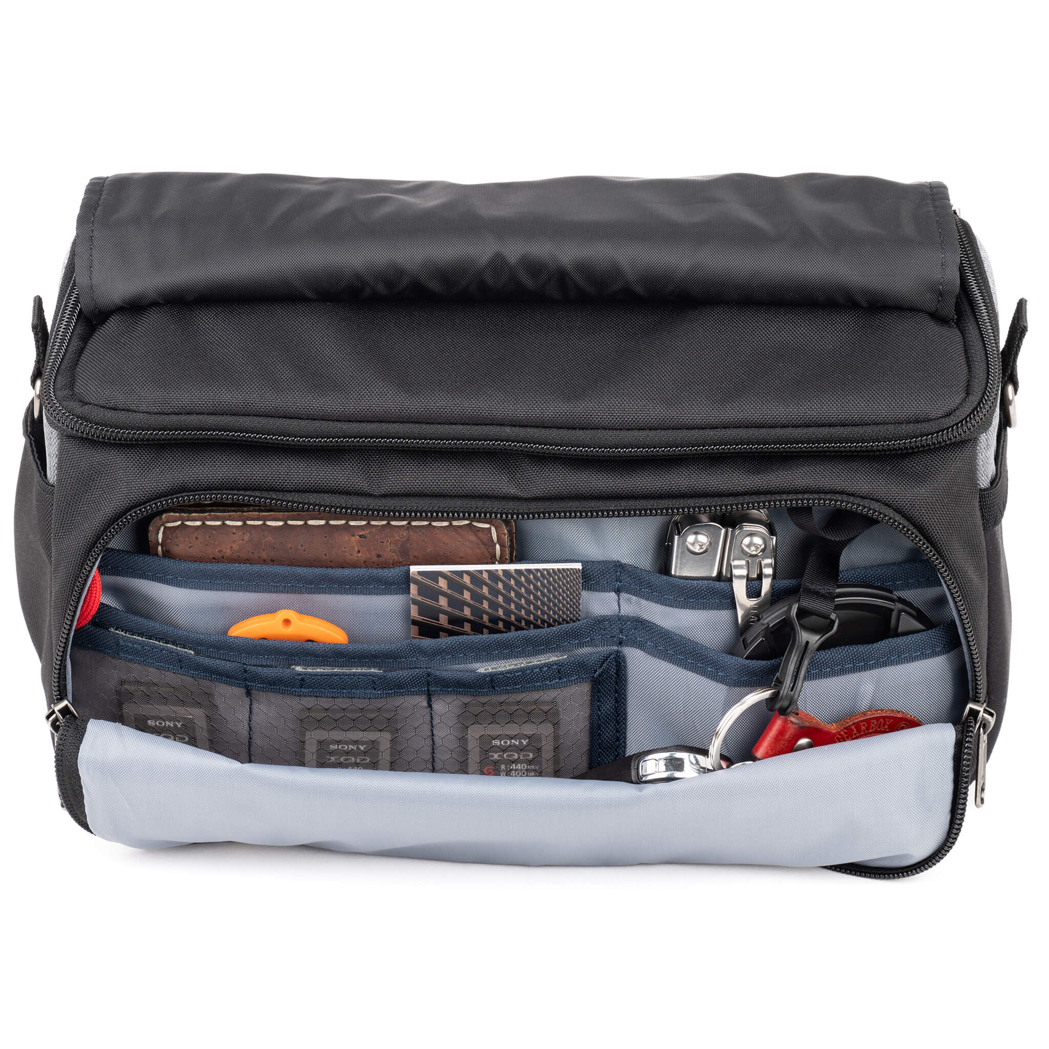 Think Tank Photo Mirrorless Mover 25 camera shoulder bag, black, compact with flip-top lid, multiple pockets, padded interior for mirrorless camera and lenses, rain cover included