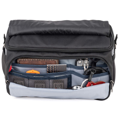 Think Tank Photo Mirrorless Mover 25 camera shoulder bag, black, compact with flip-top lid, multiple pockets, padded interior for mirrorless camera and lenses, rain cover included