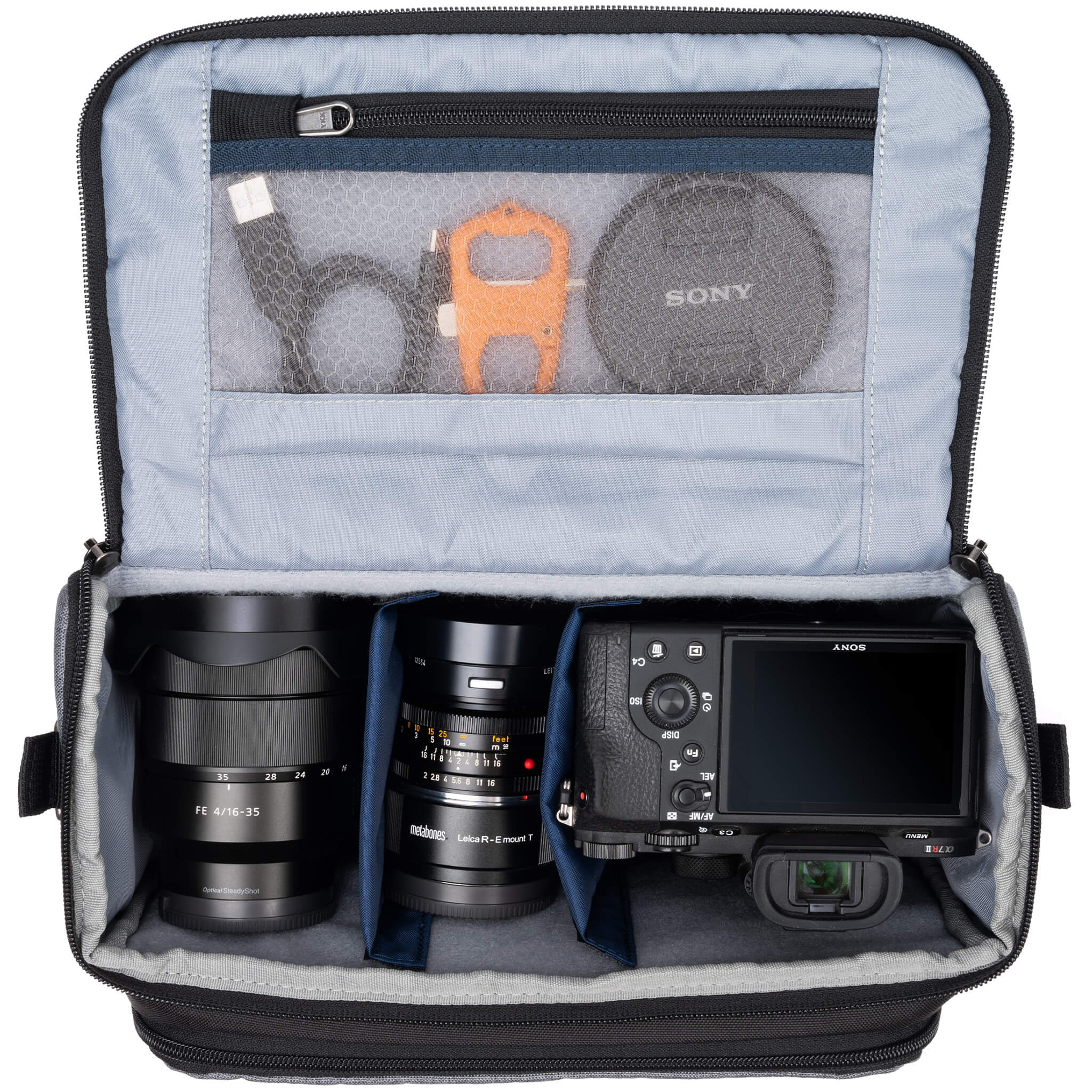 Think Tank Photo Mirrorless Mover 30 camera shoulder bag, flip-top lid with magnetic closure, multiple pockets, padded interior with adjustable dividers for mirrorless camera and lenses, rain cover included