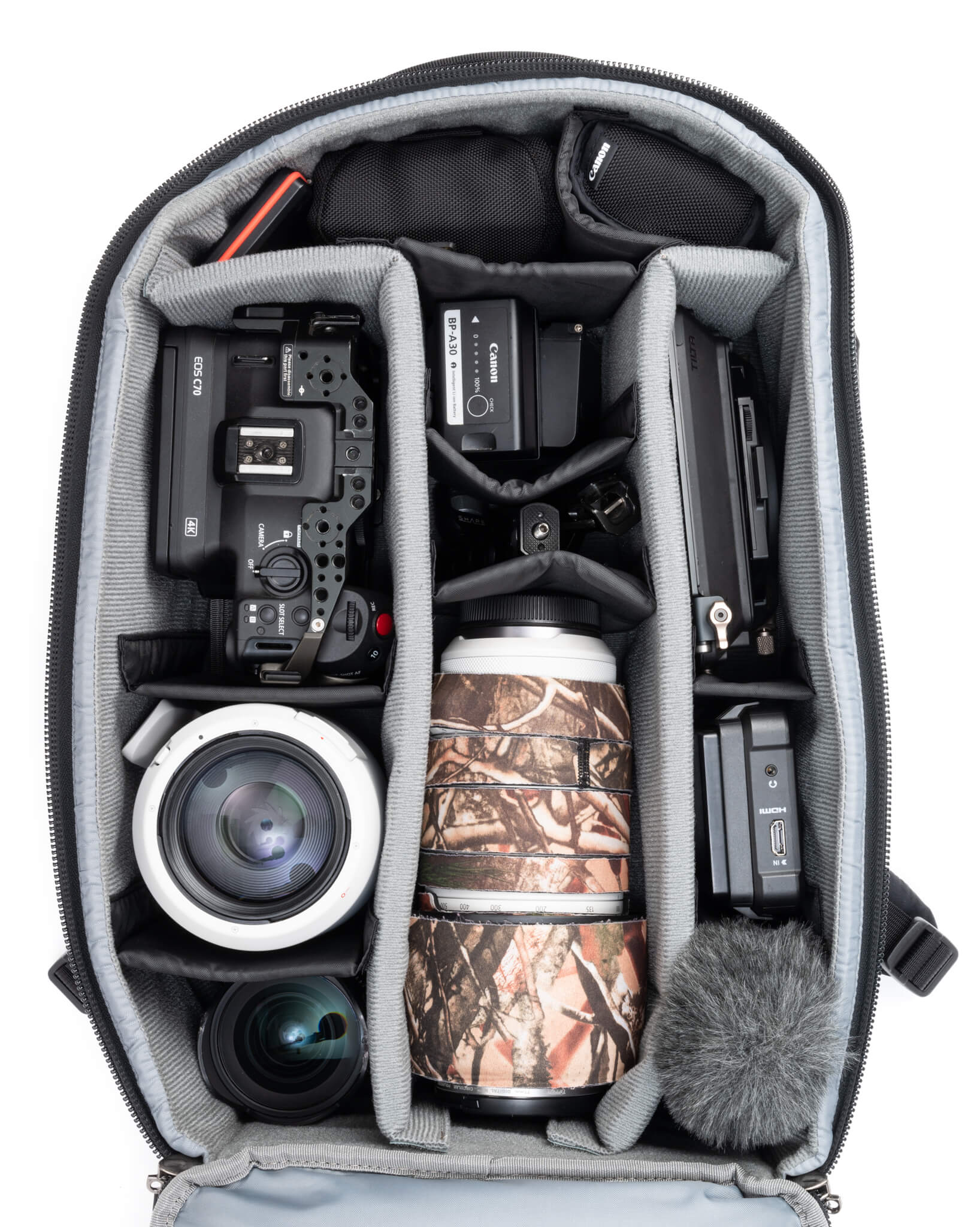 Think Tank Walker Pro backpack — rugged, roll-top camera pack in charcoal grey with side access pockets