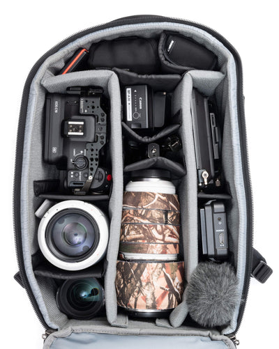 Think Tank Walker Pro backpack — rugged, roll-top camera pack in charcoal grey with side access pockets