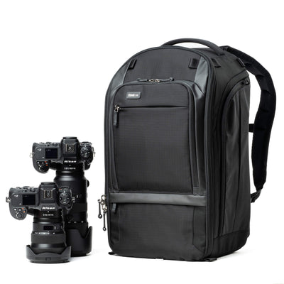 Think Tank Walker Pro backpack — rugged, roll-top camera pack in charcoal grey with side access pockets