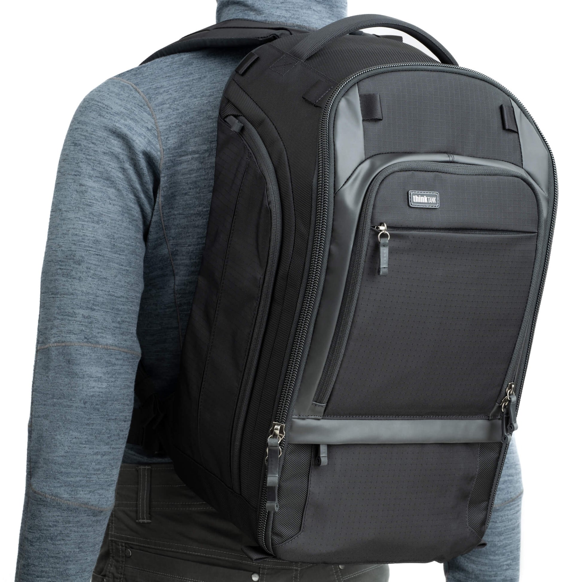 Think Tank Walker Pro backpack — rugged, roll-top camera pack in charcoal grey with side access pockets