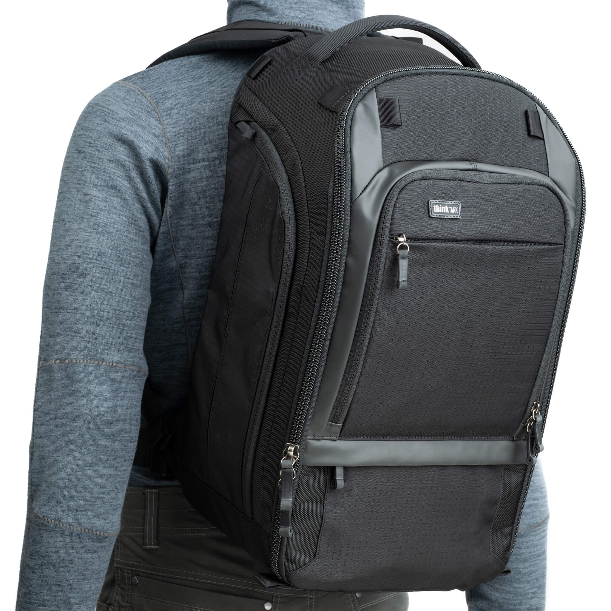 Think Tank Walker Pro backpack — rugged, roll-top camera pack in charcoal grey with side access pockets