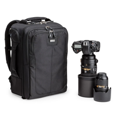 Think Tank Airport Commuter camera backpack — black carry-on bag with padded camera compartment, laptop sleeve, and side tripod straps.