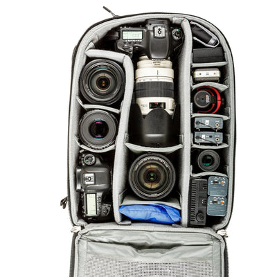 Think Tank Airport Commuter camera backpack — black carry-on bag with padded camera compartment, laptop sleeve, and side tripod straps.