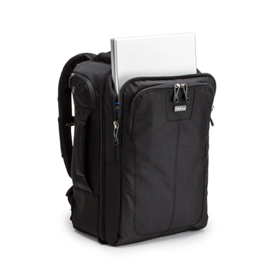 Think Tank Airport Commuter camera backpack — black carry-on bag with padded camera compartment, laptop sleeve, and side tripod straps.