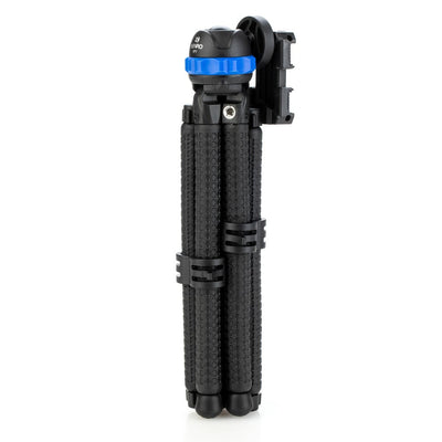 Black camera tripod with blue quick release plate on a white background