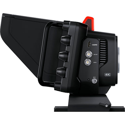 Blackmagic Design Studio Camera 4K Plus G2 with MFT lens mount, 4K UHD 3840x2160 sensor, 25,600 ISO, 12G-SDI and HDMI outputs, 7" LCD viewfinder with sunshade, Blackmagic RAW recording, and built-in DaVinci Resolve colour correction.