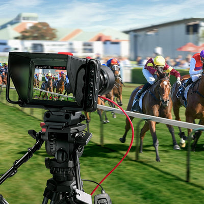 Blackmagic Design Studio Camera 4K Plus G2 with MFT lens mount, 4K UHD 3840x2160 sensor, 25,600 ISO, 12G-SDI and HDMI outputs, 7" LCD viewfinder with sunshade, Blackmagic RAW recording, and built-in DaVinci Resolve colour correction.
