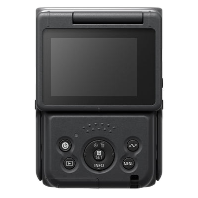 Canon PowerShot V10 Vlog Camera in black, compact rectangular body with wide-angle lens, tilting flip-up screen, and built-in stand.