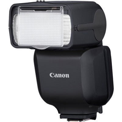 Canon Speedlite EL-10 on camera hot shoe — compact black flash unit with zooming flash head and built-in bounce diffuser card.