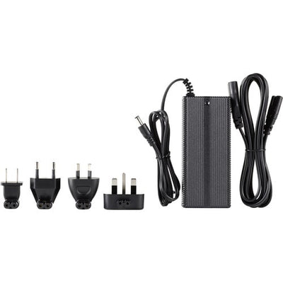 Black power adapter with multiple plug sockets on a white background