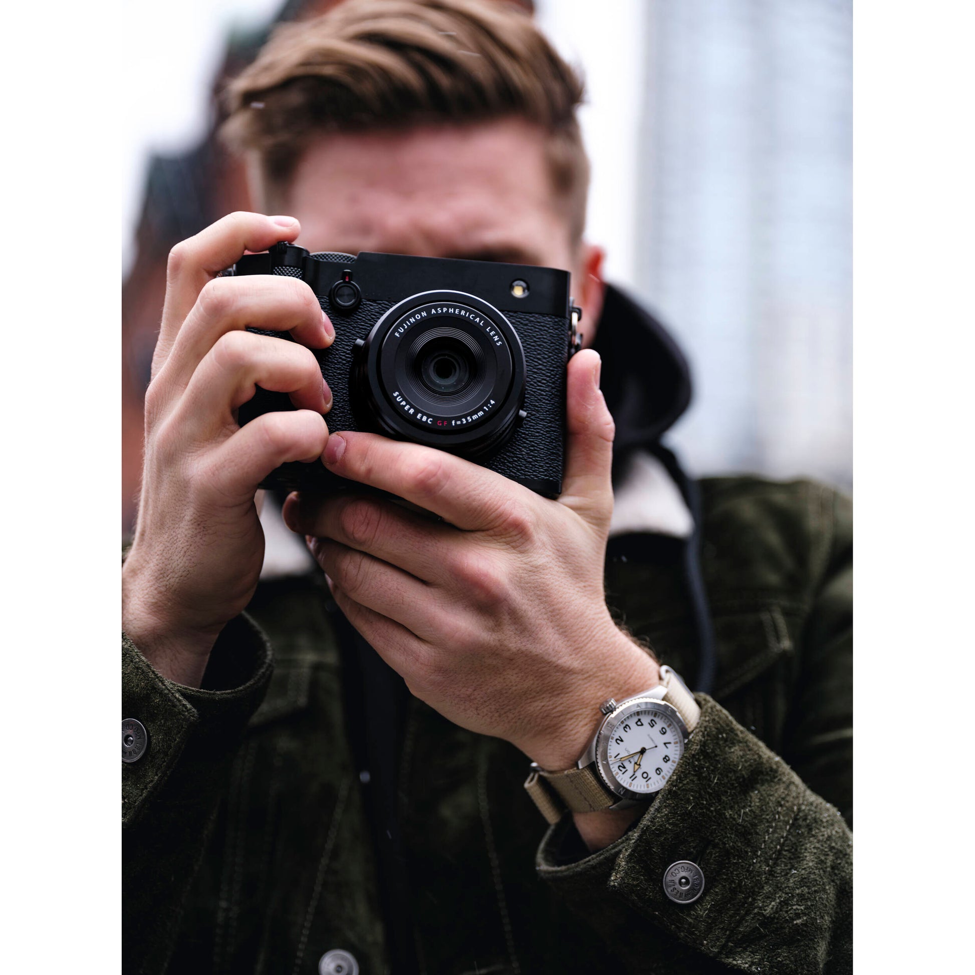 Black Fujifilm GFX 100RF digital camera featuring a compact medium format 102MP sensor, fixed 35mm f/4 lens with leaf shutter and built-in 4-stop ND filter, 3.2-inch tilting touchscreen, AI autofocus with subject detection, 4K video recording, and weather-sealed aluminum body.