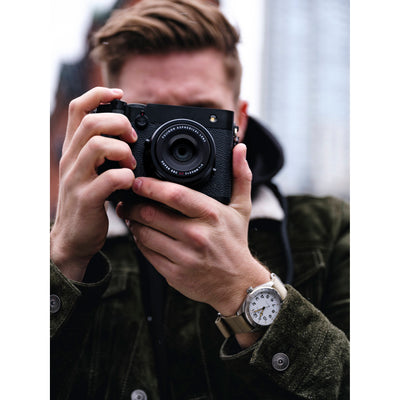 Black Fujifilm GFX 100RF digital camera featuring a compact medium format 102MP sensor, fixed 35mm f/4 lens with leaf shutter and built-in 4-stop ND filter, 3.2-inch tilting touchscreen, AI autofocus with subject detection, 4K video recording, and weather-sealed aluminum body.