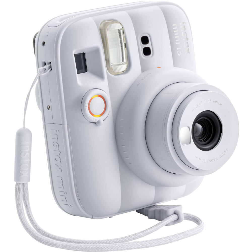 Focused front shot of White Instax 13 with wrist strap
