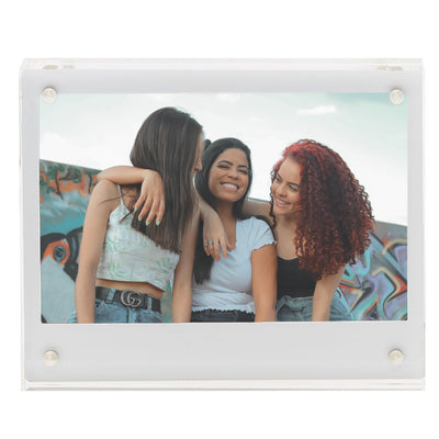 Fujifilm Instax Wide Acrylic Magnetic Frame – clear two-piece acrylic holder with four corner magnets, displaying a wide-format instant photograph and designed for easy sliding insertion on magnetic surfaces.