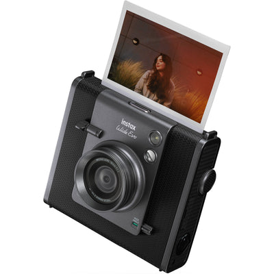 Fujifilm Instax Wide Evo hybrid instant camera with 16MP 1/3-inch CMOS sensor, fixed 16mm f/2.4 wide-angle lens, 10 lens and film effects, selfie mirror, built-in flash, tripod mount, and USB-C charging.