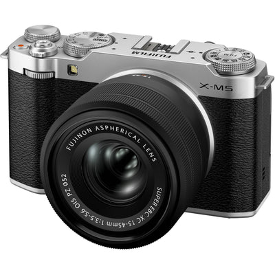 Fujifilm X-M5 silver mirrorless camera with XC 15-45mm f/3.5-5.6 OIS PZ compact zoom lens featuring 23-69mm equivalent focal length, 3-stop optical image stabilization, and smooth electric zoom