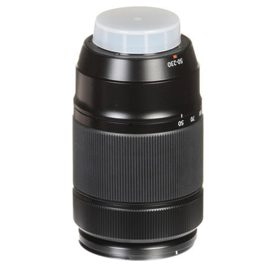 Camera lens with a white cap on a white background