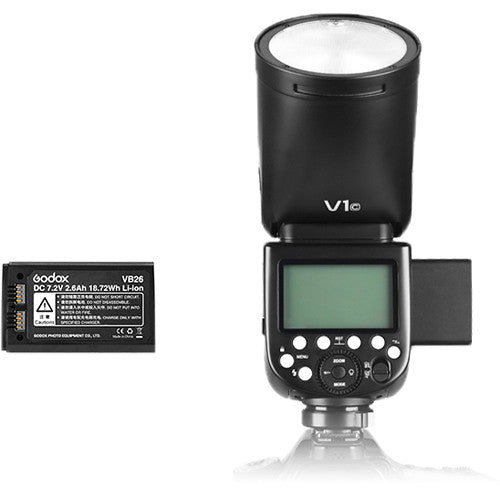 Godox V1-F round-head speedlight for Fujifilm — compact flash unit with circular flash head, LCD panel, and removable lithium-ion battery.