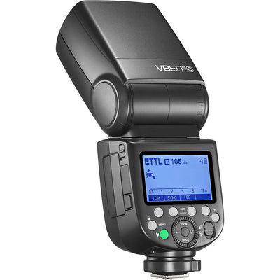 Godox V860 III speedlight for Canon, black flash unit with flip-up head, display panel, removable lithium battery, and accessories.