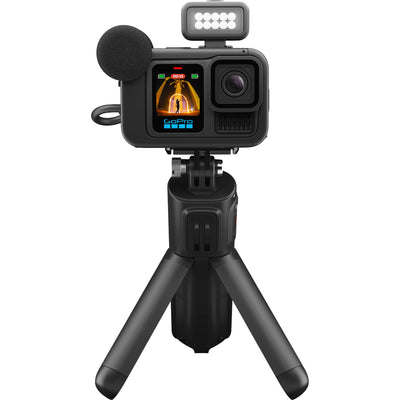 GoPro HERO13 Black Creator Edition bundled kit in black, showing the HERO13 Black camera attached to the Volta battery grip with tripod legs deployed, along with accessories including Media Mod, Light Mod, magnetic latch mount, and carrying case.