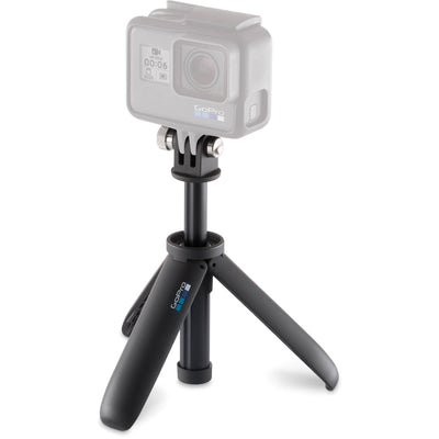 Action camera with a black mini tripod on a white background