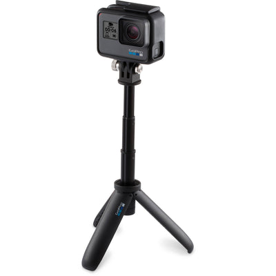GoPro camera with a black tripod on a white background