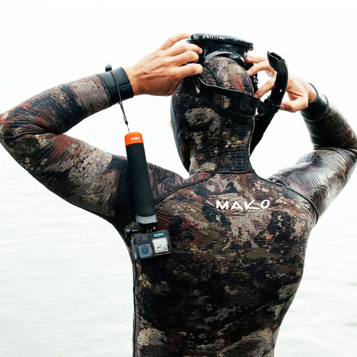 GoPro The Handler floating hand grip with orange base and quick-release camera mount
