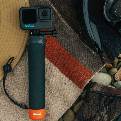 GoPro The Handler floating hand grip with orange base and quick-release camera mount
